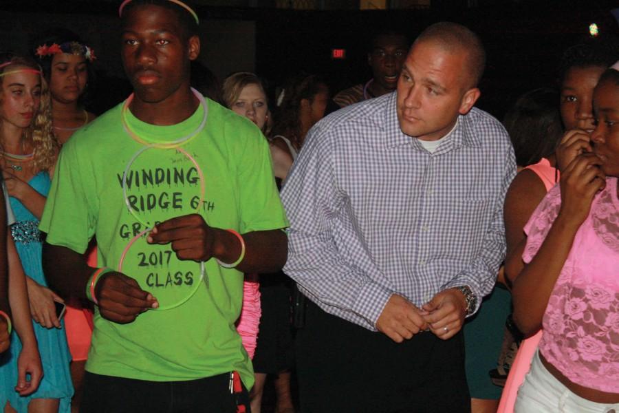 Sophomore Josh Mays and Freshman School Principal Andy Harsha getting down while also checking out their competition.