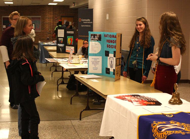 NHS members Sara Hardman, senior, and Addie Cook, junior express what activities they participate in and what they like about LN. The open house served to give prospective families an inside look into the opportunities offered at LN.