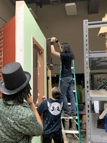 Junior Sam Rojas builds a set piece for “Little Shop of Horrors”. He is building a part of Musnik’s flower shop.