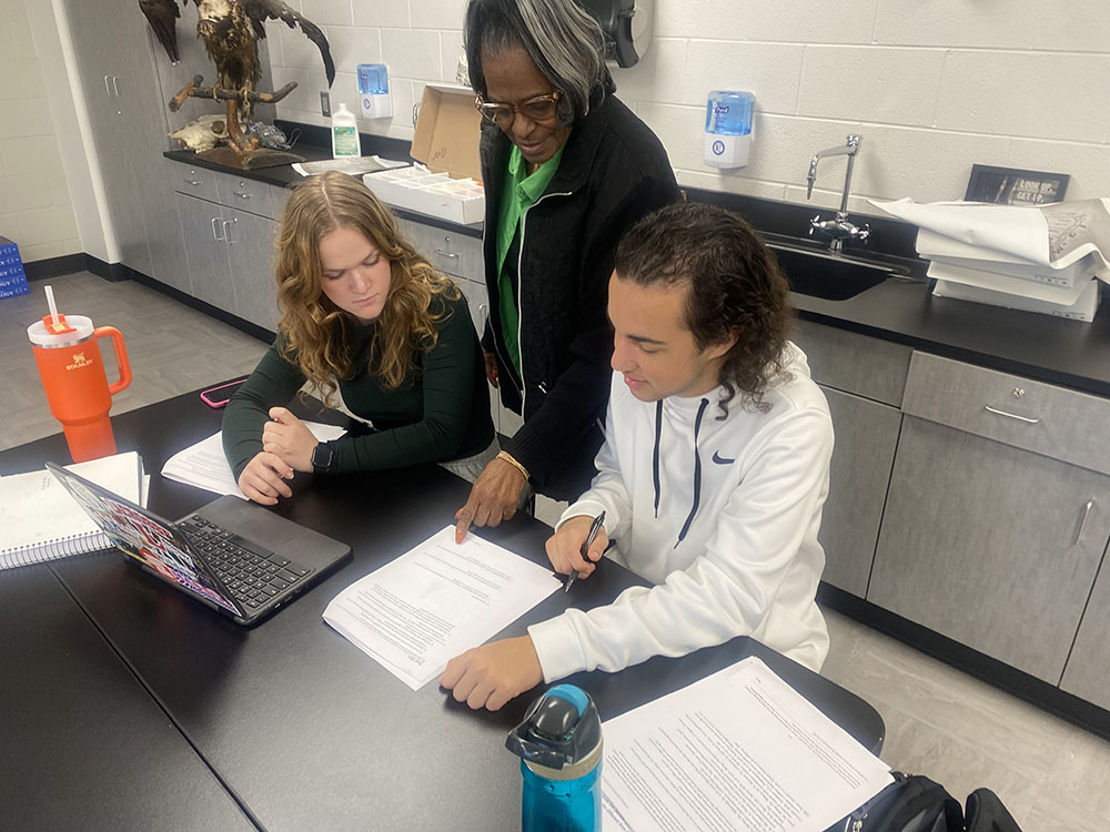 Substitute Stacy Duke helps students in AP Biology while covering that class on Tuesday, Nov. 7. Duke found out she had breast cancer several months ago and just completed treatments last month. 