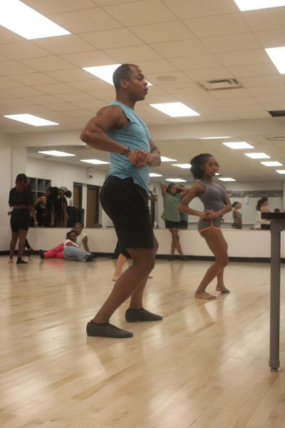 Dance director Michael Humphrey helps Fierce Feline senior captain Londyn Golden stick her pose. Golden is in her second year of being captain.