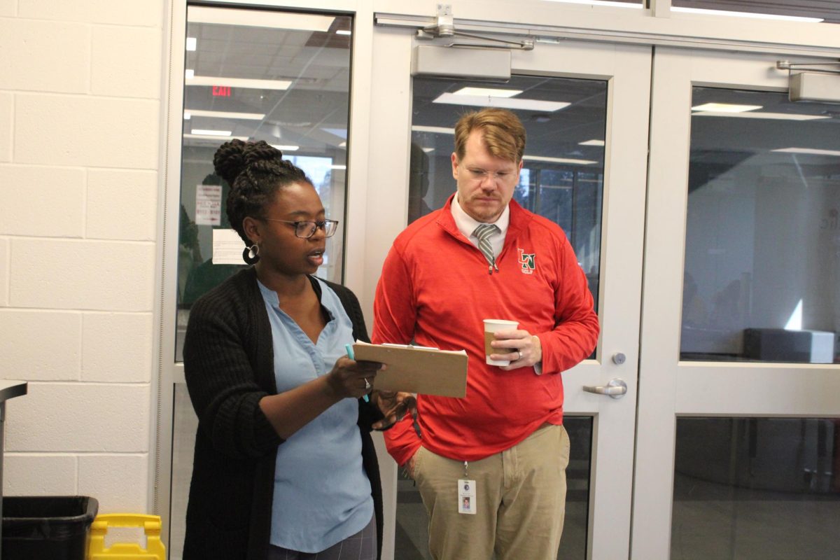 Science teacher Ronni Moore talks with new Principal Jason Floyd. Floyd was named Principal for the 25-26 school year, following Brett Crousore, who moved into the position Director of Secondary Education.